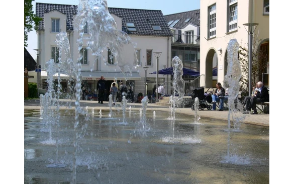 Doppelt erfrischend - der Jahnplatz Bad Sassendorf mit dem Fontänenfeld und der Eisdiele.
